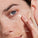 Up close of women wearing hydrogel face mask annotated with USPs; smooth wrinkles and fine lines, cools and calms, hydrates and soothes